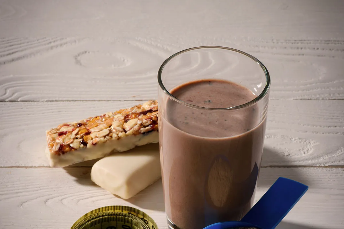 protein-bar-and-protein-shake-on-white-wood-table-cr-lightfieldstudios-envato-1700734985.jpg