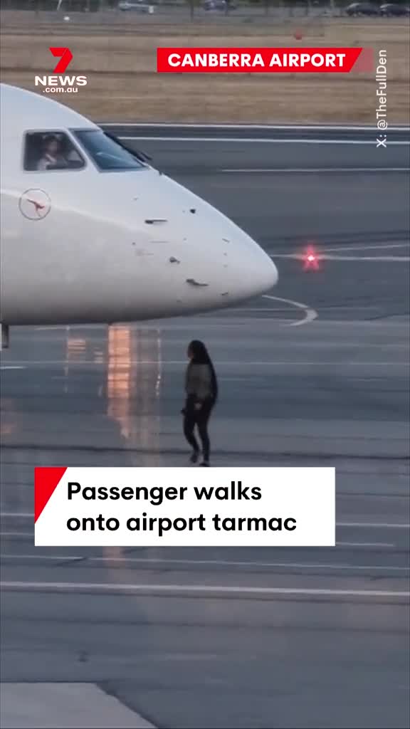 them-a-passenger-who-apparently-missed-her-flight-has-tried-to-catch-it-by-running-after-the-plane-on-the-tarmac-at-canberra-airport-the-woman-is-seen-trying-to-make-contact-with-the-pilot-who-was-watching-1698979788.mp4